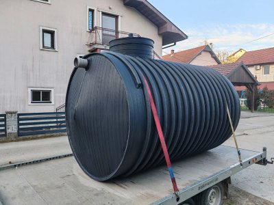 Detalj plastičnog horizontalnog rezervoara za vodu sa priključkom, postavljen u seoskom domaćinstvu u Srbiji